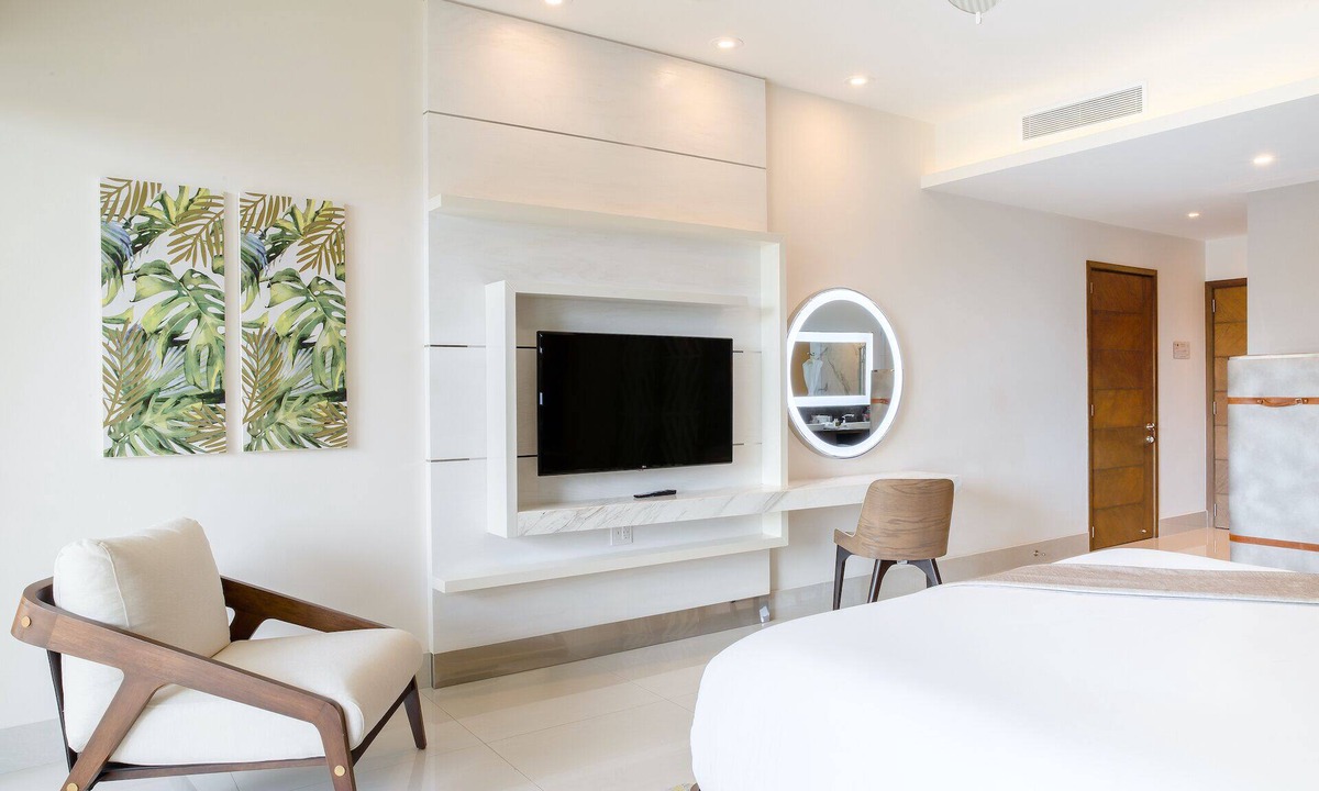 Punta Sam Resort | Cozy 588 sq ft suite with balcony, king/queen beds, and chic modern comforts.