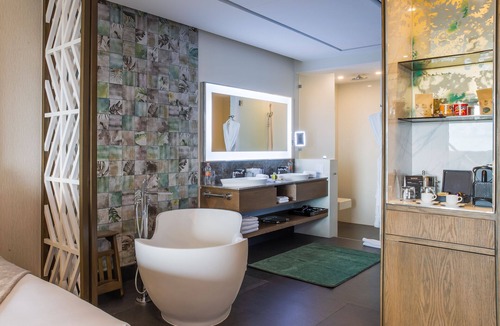 Punta Sam Resort | Cozy 588 sq ft suite with balcony, king/queen beds, and chic modern comforts.