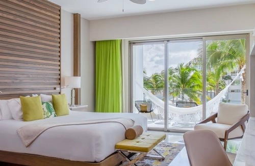 Punta Sam Resort | Cozy 588 sq ft suite with balcony, king/queen beds, and chic modern comforts.