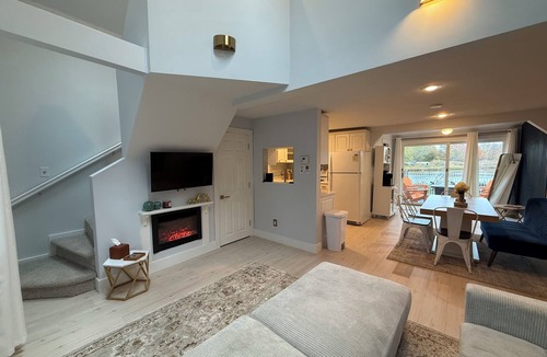 Warwick House | Freshly renovated waterfront retreat in Warwick Cove! This cozy 1-bedroom features a loft-style king bed, queen sleeper sofa, spacious deck, fenced yard, and open backyard leading to the water - perfect for a relaxing coastal escape.