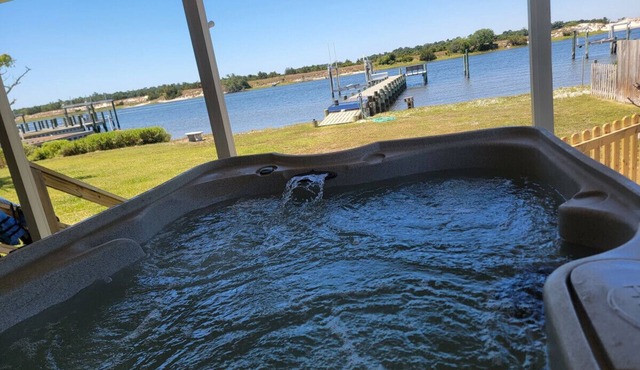 Waterfront with private dock, Hot tub, & swim mat. Large fenced backyard and screened in porch for relaxing. in Cedar Point